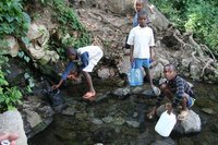 Children collecting water from the tap provided by Tengeru college
