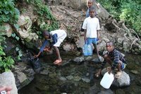 Children collecting water from the tap provided by Tengeru college Children collecting water from the tap provided by Tengeru college